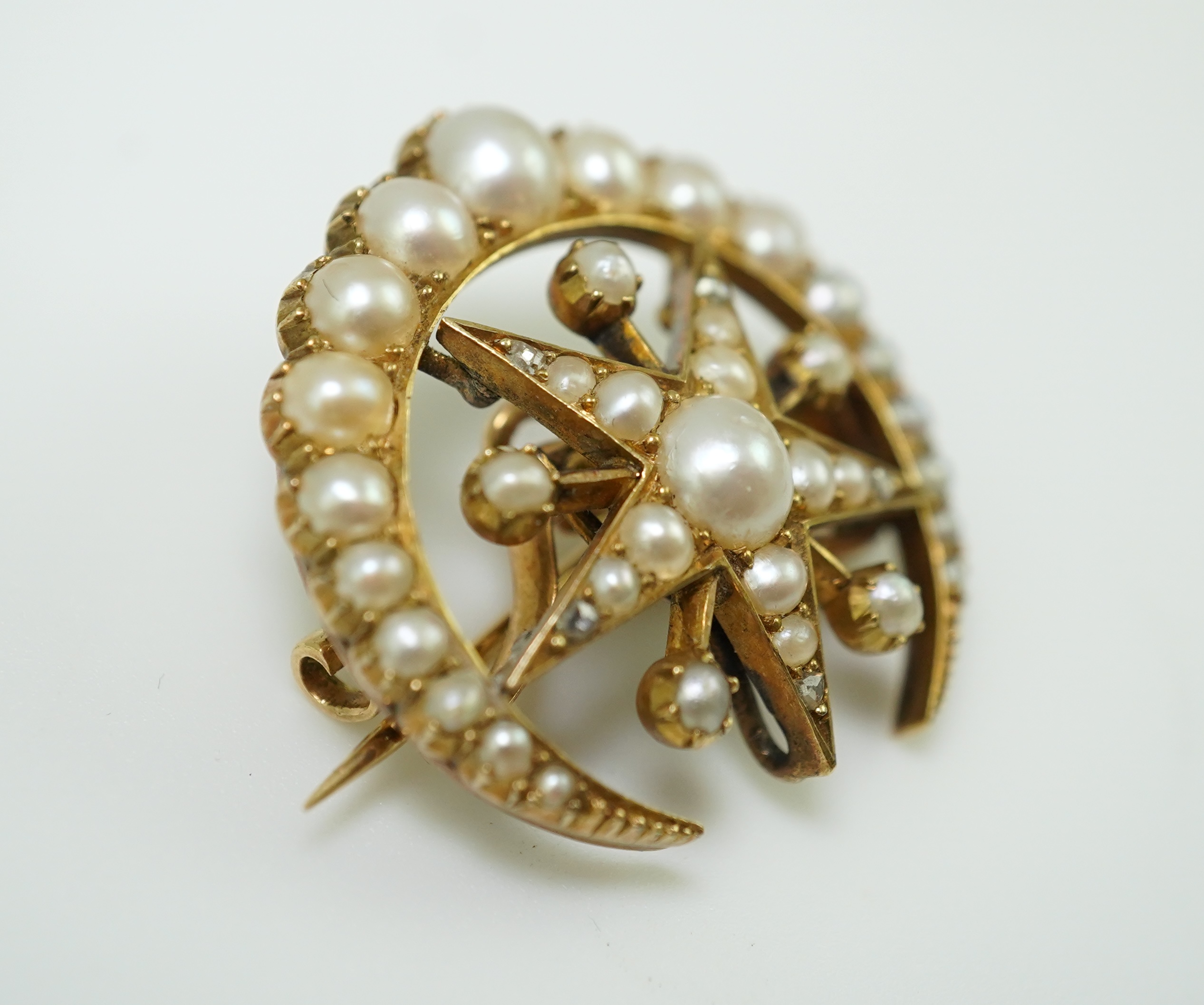 An Edwardian half pearl and diamond brooch, early 20th century